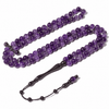 Handcrafted Amethyst Misbaha Tasbih gemstone prayer beads laid out with Ebony tassel.